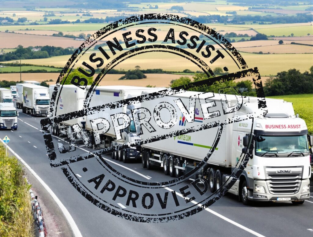 Fleet of modern lorries on a British country road with a BUSINESS ASSIST – APPROVED stamp, representing hassle-free asset finance for UK haulage and logistics firms.